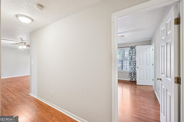 514 Mcgill Pl NE, Atlanta, GA 30312 - hall featuring a textured ceiling, wood finished floors, and baseboards