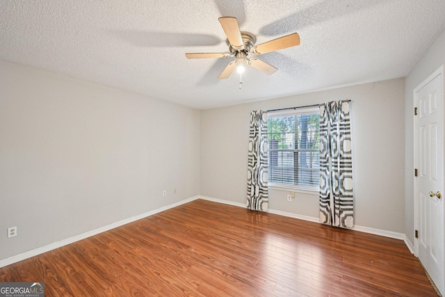 514 Mcgill Pl NE, Atlanta, GA 30312 - unfurnished room featuring ceiling fan, a textured ceiling, wood finished floors, and baseboards