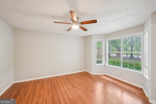 514 Mcgill Pl NE, Atlanta, GA 30312 - unfurnished room featuring wood finished floors, plenty of natural light, a textured ceiling, ceiling fan, and baseboards