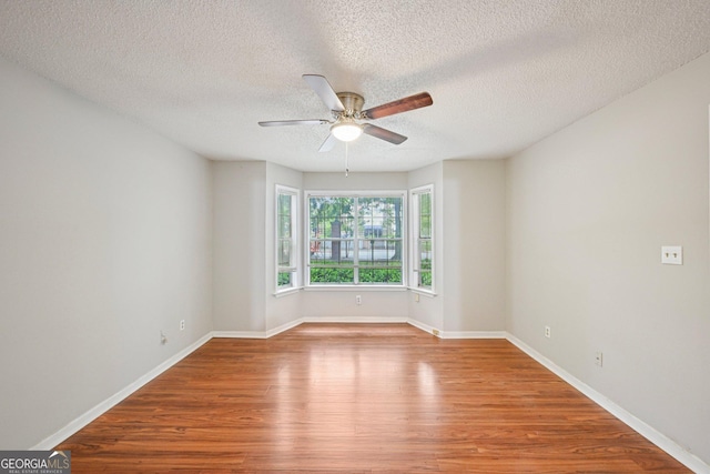 514 Mcgill Pl NE, Atlanta, GA 30312 - spare room featuring wood finished floors, ceiling fan, a textured ceiling, and baseboards