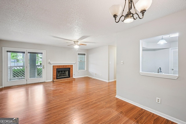 514 Mcgill Pl NE, Atlanta, GA 30312 - unfurnished living room with a textured ceiling, a ceiling fan, wood finished floors, a chandelier, and baseboards