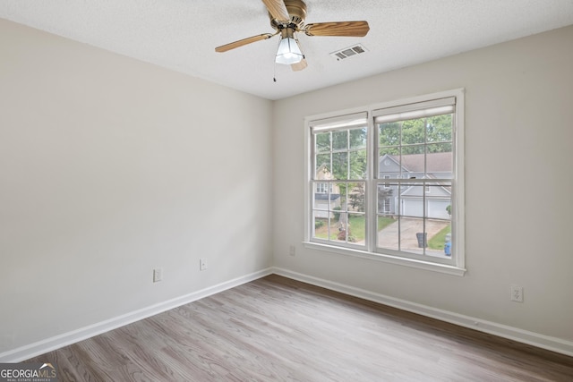 984 Wenham Ln, Lawrenceville, GA 30044 - empty room with wood finished floors, baseboards, a ceiling fan, and a textured ceiling