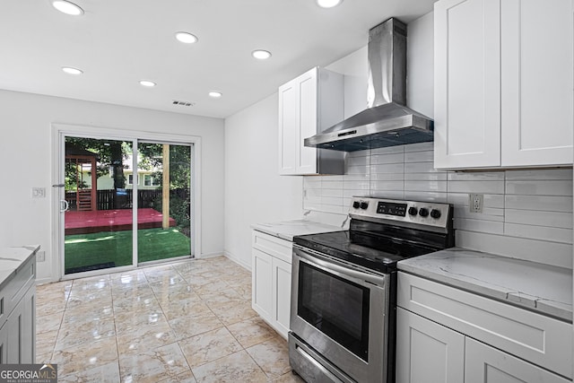 984 Wenham Ln, Lawrenceville, GA 30044 - kitchen featuring stainless steel range with electric stovetop, wall chimney exhaust hood, light stone counters, recessed lighting, and tasteful backsplash