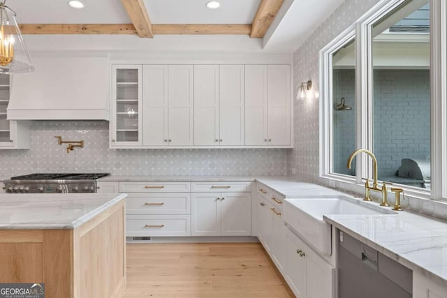 615 Claxton Ln, Milton, GA 30004 - kitchen featuring light wood-type flooring, beamed ceiling, custom range hood, light stone countertops, and white cabinets