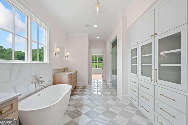 615 Claxton Ln, Milton, GA 30004 - bathroom with a soaking tub, a shower stall, vanity, tile patterned floors, and ornamental molding