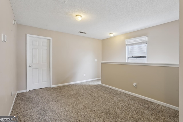 7813 Newbury Dr, Jonesboro, GA 30236 - carpeted empty room featuring a textured ceiling and baseboards