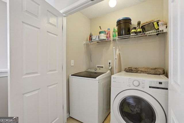 7813 Newbury Dr, Jonesboro, GA 30236 - laundry area with washer and dryer and a textured ceiling