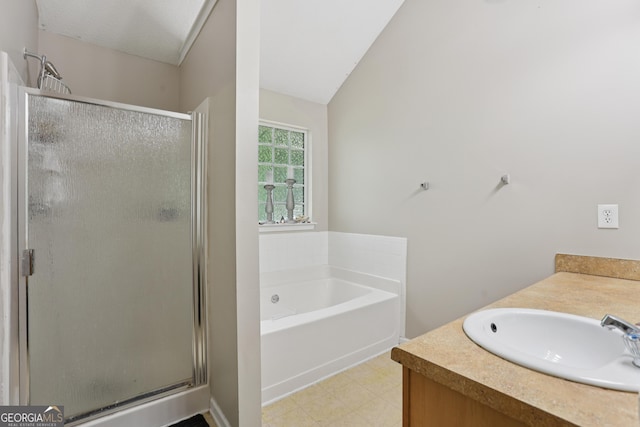 7813 Newbury Dr, Jonesboro, GA 30236 - bathroom with a shower stall, a garden tub, vanity, and vaulted ceiling