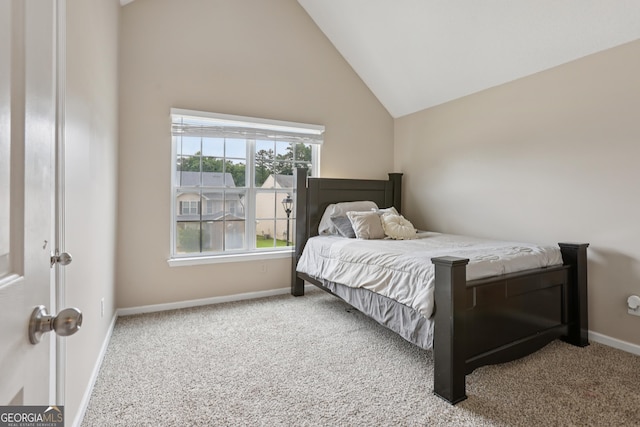 7813 Newbury Dr, Jonesboro, GA 30236 - carpeted bedroom with baseboards and high vaulted ceiling