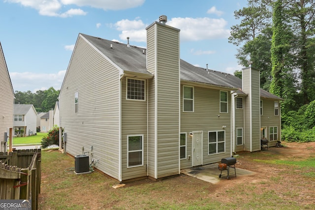 7813 Newbury Dr, Jonesboro, GA 30236 - back of house featuring a chimney, central AC, and a patio area
