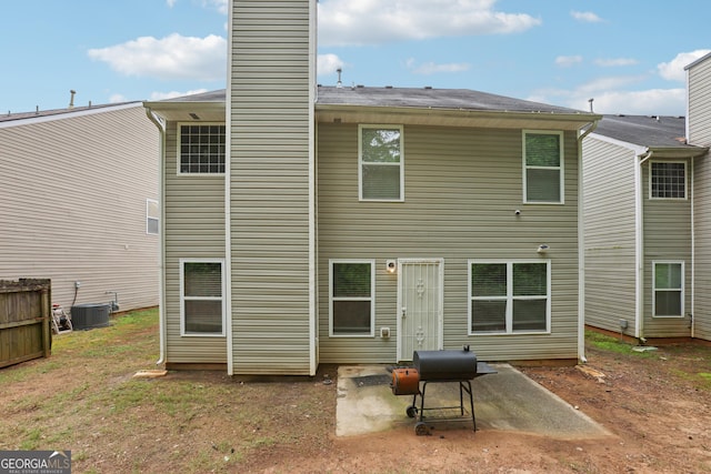 7813 Newbury Dr, Jonesboro, GA 30236 - back of house featuring a patio, cooling unit, and a chimney