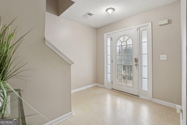 7813 Newbury Dr, Jonesboro, GA 30236 - foyer with baseboards and a textured ceiling