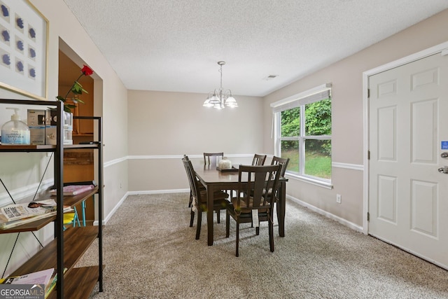 7813 Newbury Dr, Jonesboro, GA 30236 - carpeted dining area with baseboards, a textured ceiling, and a chandelier