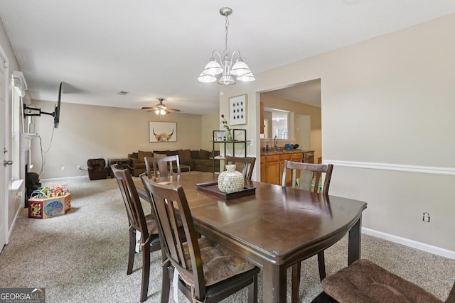 7813 Newbury Dr, Jonesboro, GA 30236 - dining space featuring light colored carpet, baseboards, a ceiling fan, and a chandelier