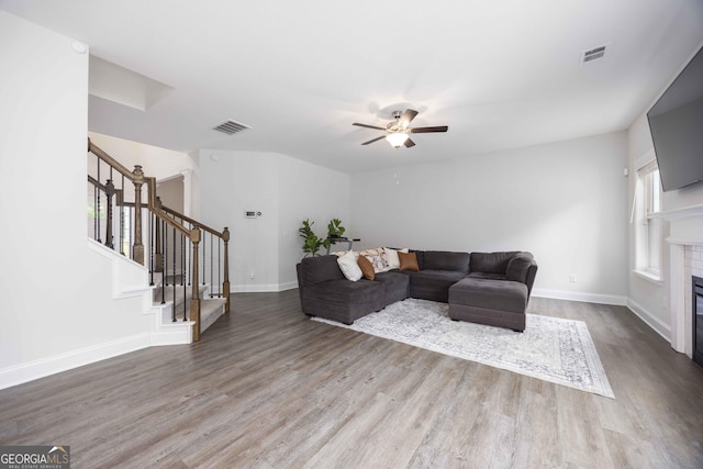 9929 Long Leaf Pine Dr, Midland, GA 31820 - living area featuring wood finished floors, stairs, ceiling fan, baseboards, and a tile fireplace