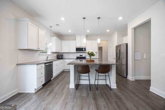 9929 Long Leaf Pine Dr, Midland, GA 31820 - kitchen with stainless steel appliances, a kitchen island, baseboards, decorative backsplash, and recessed lighting