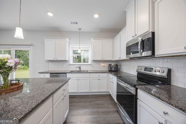 9929 Long Leaf Pine Dr, Midland, GA 31820 - kitchen featuring appliances with stainless steel finishes, white cabinetry, plenty of natural light, dark wood-style floors, and recessed lighting