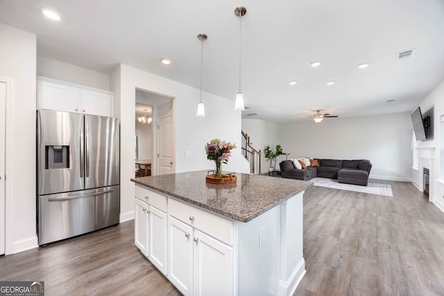 9929 Long Leaf Pine Dr, Midland, GA 31820 - kitchen with stainless steel fridge with ice dispenser, a center island, stone counters, light wood-type flooring, and ceiling fan