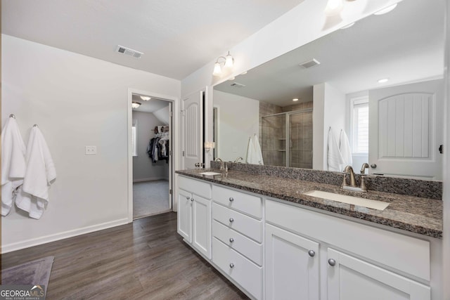 9929 Long Leaf Pine Dr, Midland, GA 31820 - full bathroom with double vanity, a stall shower, wood finished floors, a spacious closet, and baseboards