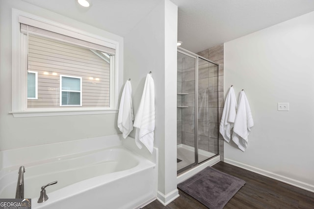9929 Long Leaf Pine Dr, Midland, GA 31820 - bathroom featuring a garden tub, a shower stall, wood finished floors, and baseboards