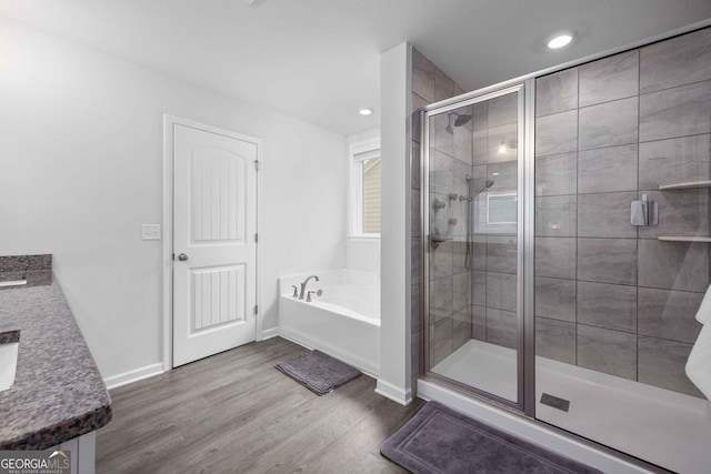 9929 Long Leaf Pine Dr, Midland, GA 31820 - bathroom featuring a bath, a shower stall, vanity, wood finished floors, and baseboards