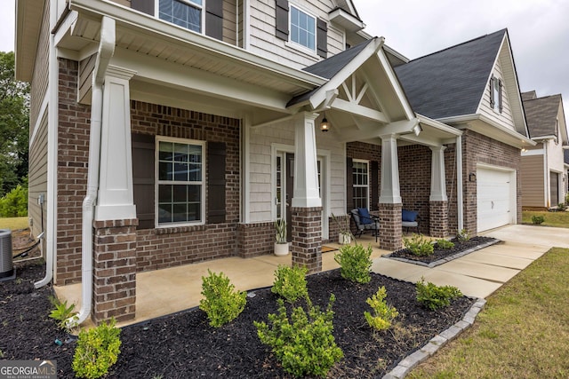9929 Long Leaf Pine Dr, Midland, GA 31820 - view of front facade featuring a porch, brick siding, concrete driveway, and central air condition unit