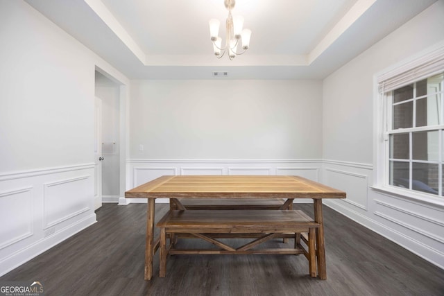 9929 Long Leaf Pine Dr, Midland, GA 31820 - dining space with a tray ceiling, a chandelier, dark wood-type flooring, a decorative wall, and wainscoting