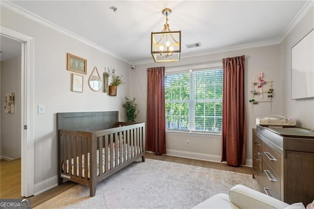 3088 Steeplechase Dr, Alpharetta, GA 30004 - bedroom with wood finished floors, baseboards, crown molding, and a nursery area