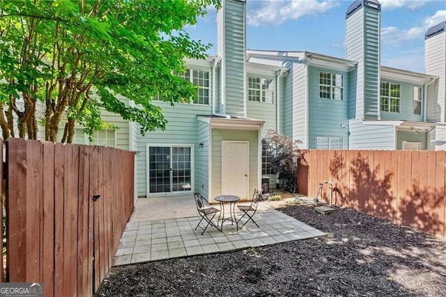 3088 Steeplechase Dr, Alpharetta, GA 30004 - rear view of house with a chimney and a patio