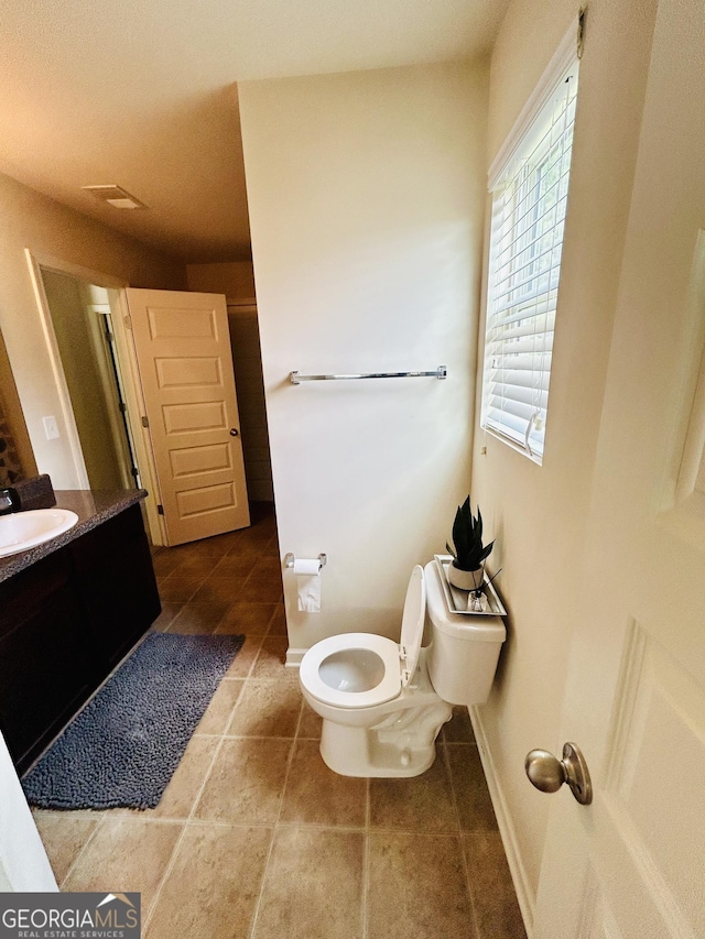 5848 Rex Ridge Loop, Rex, GA 30273 - bathroom featuring vanity, toilet, tile patterned flooring, and baseboards