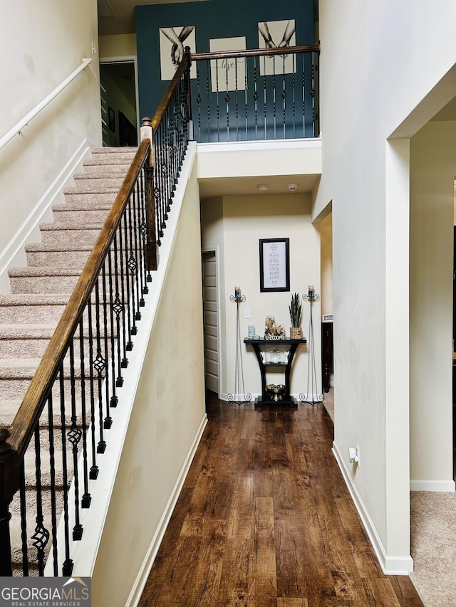 5848 Rex Ridge Loop, Rex, GA 30273 - staircase featuring a high ceiling, wood-type flooring, and baseboards
