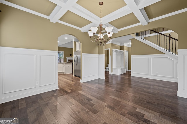 108 Donovan Ave, Locust Grove, GA 30248 - unfurnished dining area with arched walkways, a decorative wall, coffered ceiling, a chandelier, and beam ceiling