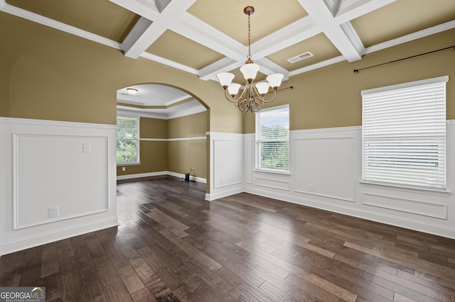 108 Donovan Ave, Locust Grove, GA 30248 - empty room featuring arched walkways, a chandelier, coffered ceiling, wainscoting, and dark wood-style flooring