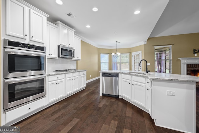 108 Donovan Ave, Locust Grove, GA 30248 - kitchen featuring appliances with stainless steel finishes, a sink, a chandelier, dark wood-style flooring, and recessed lighting
