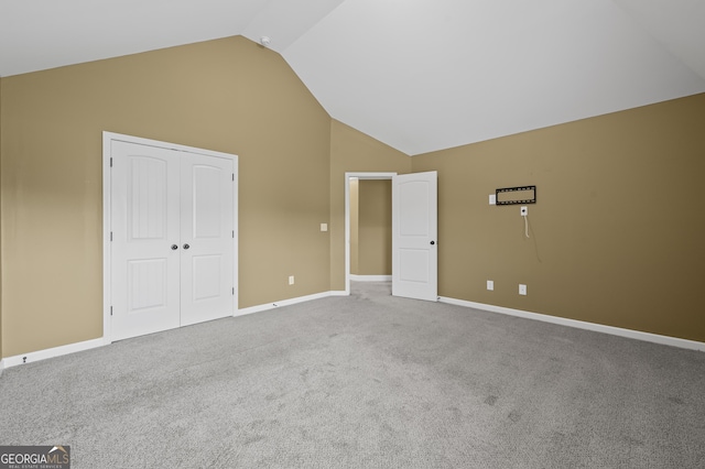 108 Donovan Ave, Locust Grove, GA 30248 - unfurnished bedroom featuring carpet, baseboards, a closet, and high vaulted ceiling