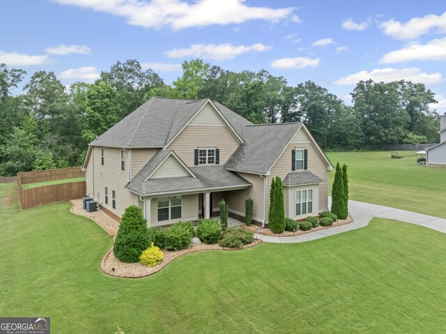108 Donovan Ave, Locust Grove, GA 30248 - view of front of house with roof with shingles, view of wooded area, and central air condition unit