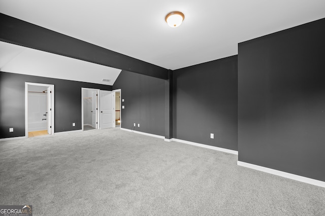 108 Donovan Ave, Locust Grove, GA 30248 - carpeted spare room with vaulted ceiling and baseboards