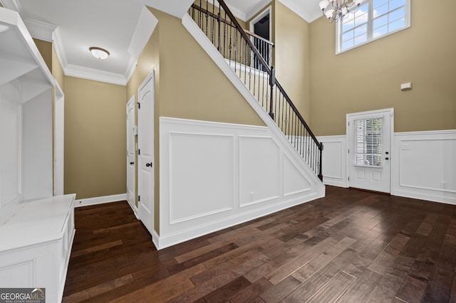 108 Donovan Ave, Locust Grove, GA 30248 - foyer featuring a chandelier, crown molding, a decorative wall, stairs, and dark wood-style floors