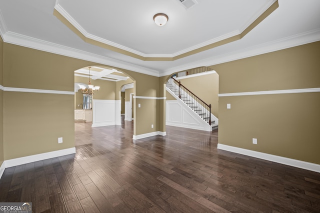 108 Donovan Ave, Locust Grove, GA 30248 - spare room with arched walkways, stairway, wood finished floors, a chandelier, and ornamental molding