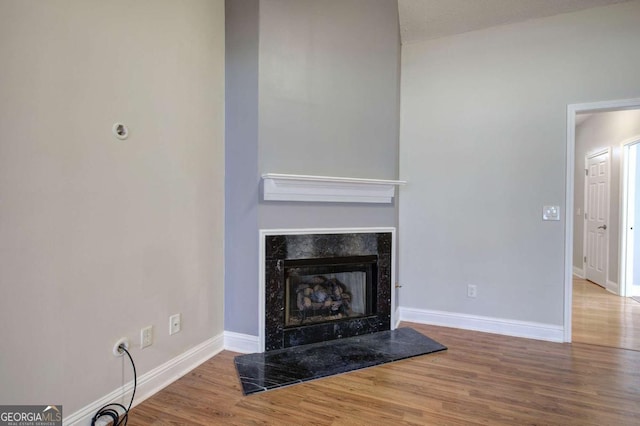 2500 Rosehill Cir, Lithia Springs, GA 30122 - unfurnished living room with wood finished floors and a premium fireplace