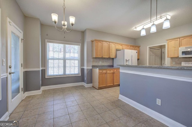 2500 Rosehill Cir, Lithia Springs, GA 30122 - kitchen with white appliances, tasteful backsplash, a chandelier, light tile patterned floors, and decorative light fixtures