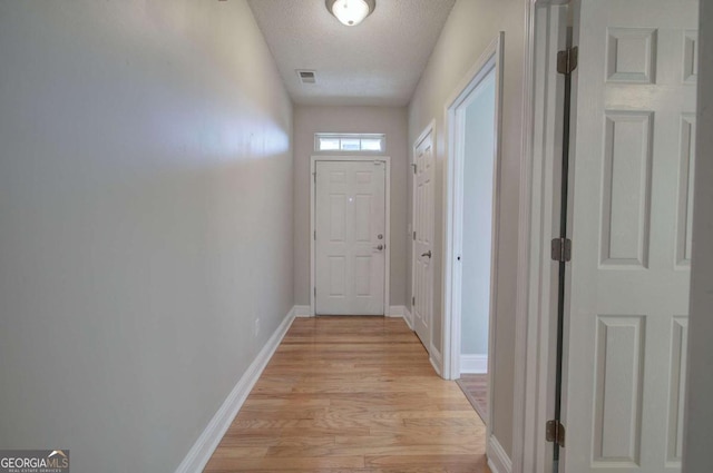 2500 Rosehill Cir, Lithia Springs, GA 30122 - doorway with light wood-type flooring and a textured ceiling