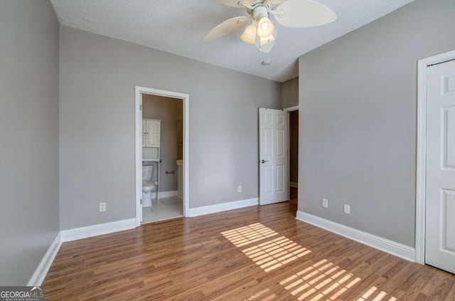 2500 Rosehill Cir, Lithia Springs, GA 30122 - unfurnished bedroom with wood finished floors, ensuite bathroom, and ceiling fan