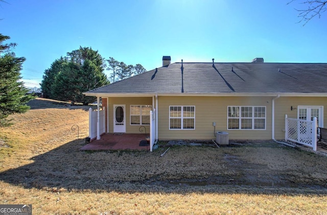 2500 Rosehill Cir, Lithia Springs, GA 30122 - back of property with a patio area, a chimney, and a lawn