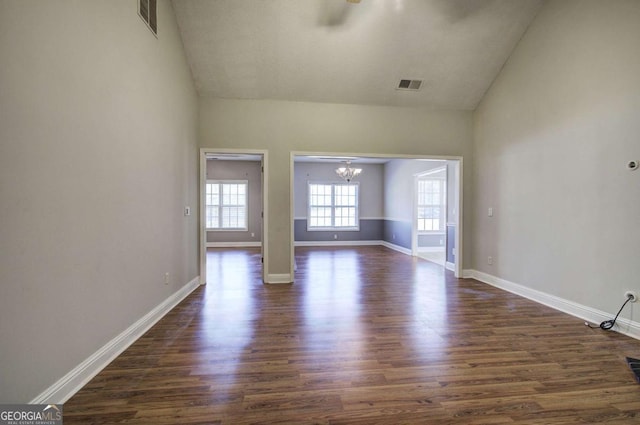 2500 Rosehill Cir, Lithia Springs, GA 30122 - unfurnished living room with a chandelier, high vaulted ceiling, and dark wood finished floors
