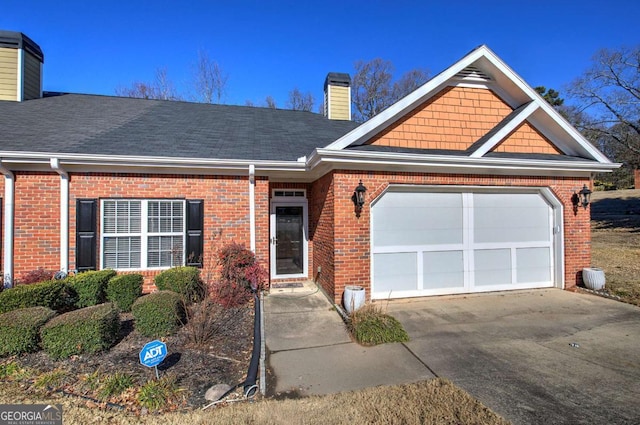 2500 Rosehill Cir, Lithia Springs, GA 30122 - view of front of house with a chimney, concrete driveway, brick siding, and a garage