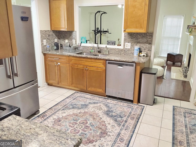 3332 Glenrose Trl, Chamblee, GA 30341 - kitchen with appliances with stainless steel finishes, light tile patterned floors, decorative backsplash, and light stone countertops