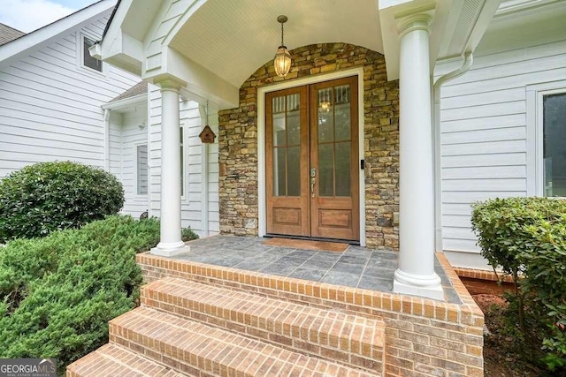 326 Seldom Seen Trl, Canton, GA 30115 - property entrance featuring stone siding, french doors, and a porch
