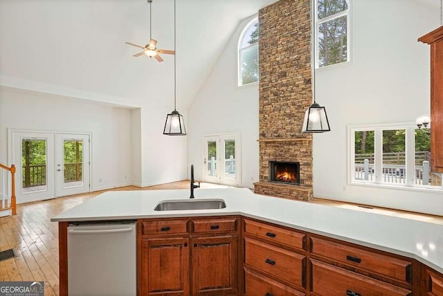 326 Seldom Seen Trl, Canton, GA 30115 - kitchen with high vaulted ceiling, open floor plan, stainless steel dishwasher, ceiling fan, and plenty of natural light