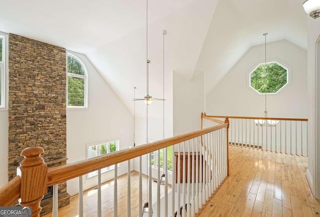 326 Seldom Seen Trl, Canton, GA 30115 - hallway featuring lofted ceiling, light wood finished floors, a chandelier, and an upstairs landing